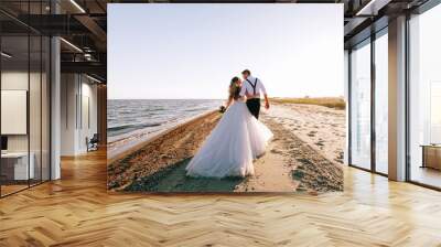 bride and groom on the seashore. wedding concept on the sea, on a fabulous island. Wall mural