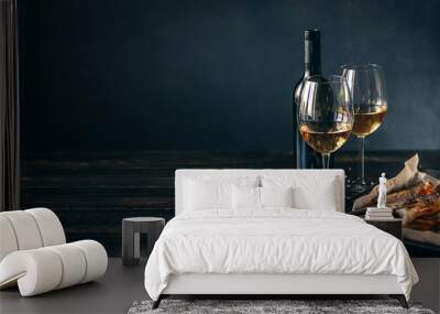 dinner concept for two. two glasses of white wine, baked fish. Wall mural