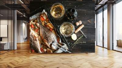 dinner concept for two. two glasses of white wine, baked fish. Wall mural