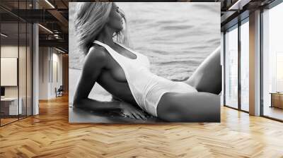 Slim and athletic girl in a swimsuit on the beach Wall mural