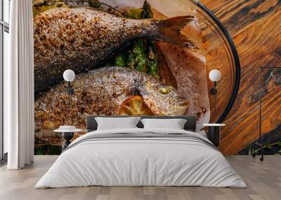 the concept of a delicious dinner for two from dorado. baked dorado fish with asparagus and lemon in spices Wall mural