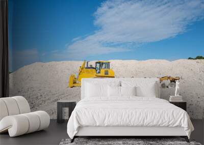 Yellow bulldozer moving limestone in the quarry. Faxe Kalkbrud, Denmark Wall mural