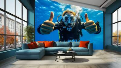 Closeup of scuba diver underwater in blue ocean, smiling and giving thumbs up during vacation Wall mural