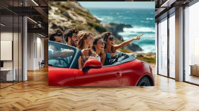 Happy young friends in a red cabriolet enjoying a beach day and exploring with a map Wall mural