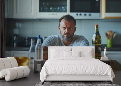 Man at kitchen table with alcohol and water, contrasting lifestyle choices and health impact Wall mural