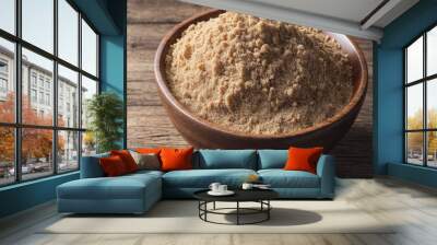 A bowl of brown powder sits on a wooden table Wall mural