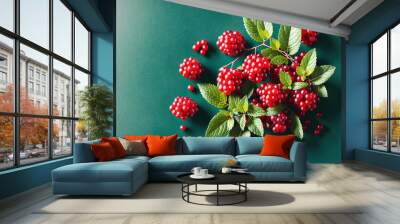 A bunch of ripe raspberries on a green background. Wall mural