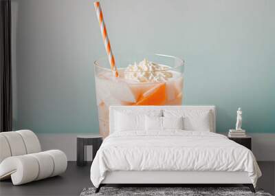 A glass of Orange Creamsicle Float drink with a straw in it Wall mural