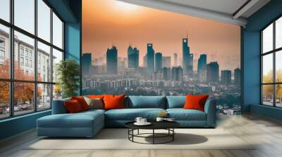 The Shanghai skyline at sunset, with tall buildings silhouetted against the orange sky Wall mural