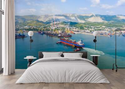 Industrial seaport Novorossiysk , top view. Port cranes and cargo ships and barges. Loading and shipment of cargo at the port. View of the sea cargo port with a bird's eye view. Wall mural