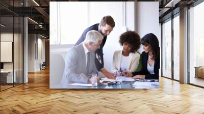 Business people, teamwork and meeting with brainstorming in office for financial review, feedback and diversity. Professional, employees and collaboration in boardroom with lens flare and strategy Wall mural