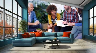 Feeling good about this team. Shot of a group of happy coworkers in a meeting. Wall mural