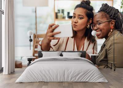 Just call us the selfie queens. Shot of two young women taking selfies at cafe. Wall mural