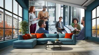 Moulding their ideas around success. Cropped shot of a group of young creatives having a meeting in a modern office. Wall mural