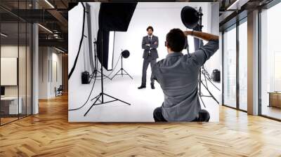 Photo craft. Shot of a photographer working in his studio. Wall mural