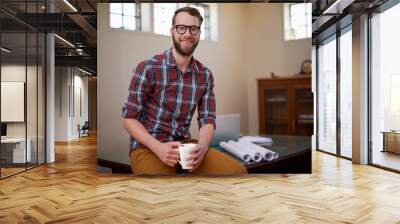 Portrait, laptop and architect in office with smile for career in construction industry and coffee. Man, contractor and entrepreneur of startup, small business and blueprint with floor plan on desk Wall mural