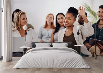 Shes fully engaged in the discussion. Shot of a young businesswoman raising her hand during a conference. Wall mural