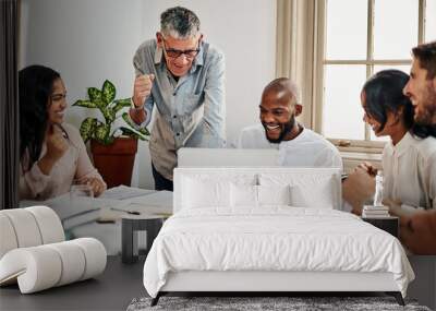 When you finally see your designs online. Shot of a group of businesspeople cheering while using a laptop during a meeting in a modern office. Wall mural