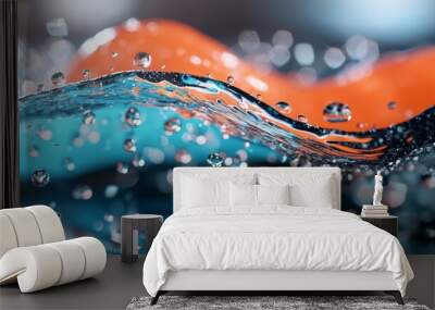  A detailed view of a blue-orange wave with water droplets at its base, and an underlying orange wave Wall mural