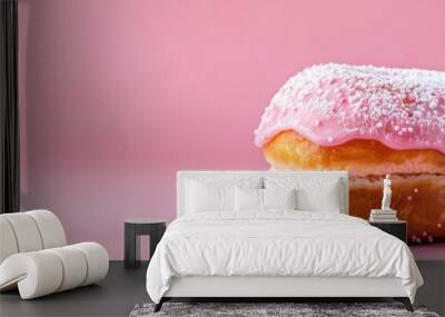  A donut with pink icing and sprinkles atop a pink surface against a pink backdrop Wall mural