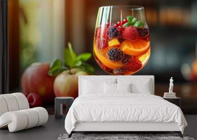   A glass holding fruits sits on the table An apple and another fruit rest adjacent on the table's surface Wall mural