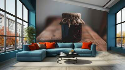  A jar of jam sits on a worn wooden table A burlap sack rests atop the jar A ruddy wooden chair stands behind the scene Wall mural