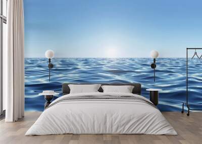  A large body of water beneath a blue sky, with the sun casting golden rays upon its blue horizon Wall mural