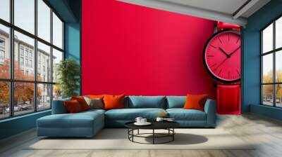  A red watch with a black face against a red background The clock face casts a shadow Wall mural