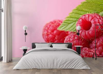  A tight shot of a cluster of raspberries, each with a verdant leaf atop Wall mural