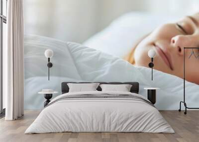  A tight shot of a person reclining on a bed with a white comforter and crisp sheets, a window providing the backdrop Wall mural