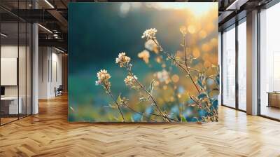  A wildflower field bathed in sunlight, trees and grass framing the scene in the foreground Wall mural