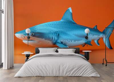  An image of a toy shark on an orange background with two orange walls behind it Wall mural