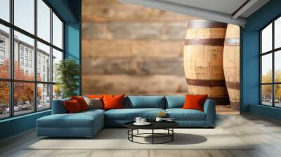  Two barrels, made of wood, sit side by side on a wooden table A wall of wood planks lies behind them Wall mural