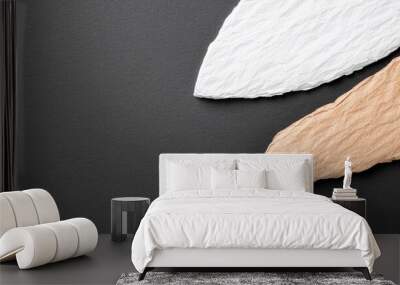  Two wooden pieces atop a black table, adjacent to a white and brown paper Wall mural