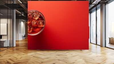 a glass holding ice cubes sits atop a red table nearby, a cup of ice rests on a red counter top both Wall mural