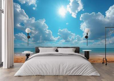 a sunny day at the beach with clouds in the sky and a blue sky with white clouds over the ocean. Wall mural