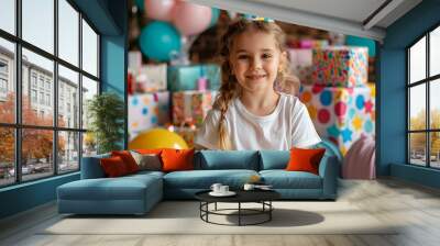 A young girl in a festive polka-dotted party hat and colorful skirt, celebrating a birthday party with balloons and cake in the background Wall mural