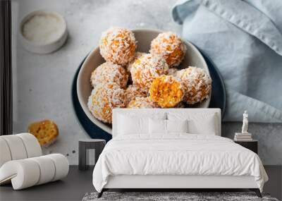 apricot coconut bliss balls in blue bowl on gray background. raw vegan dessert without sugar. close-up Wall mural