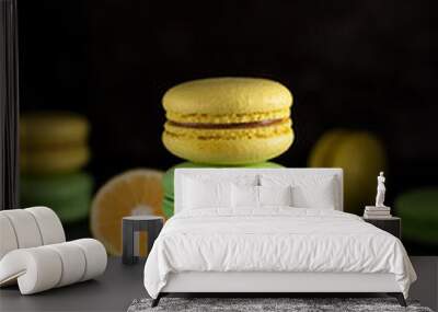 yellow and green macarons. french delicious dessert. dark background Wall mural