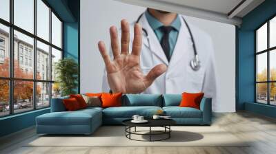 A doctor is wearing a white lab coat and a blue tie Wall mural