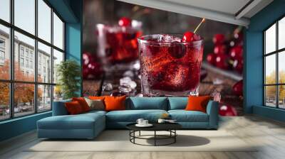 A glass of cherry juice with a cherry on top Wall mural