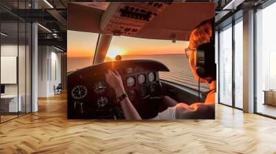 Beautiful young woman in white dress and headphones driving a helicopter at sunset. Generative AI Wall mural