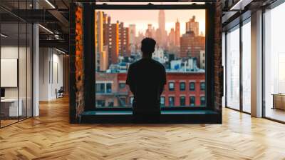 person standing in front of a window, looking out at the city and thinking Wall mural