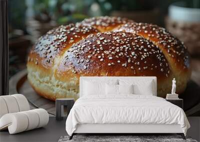 Freshly baked golden brioche with sesame seeds on wooden platter Wall mural