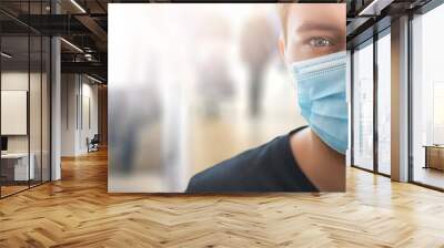 Airport young man tourist taking a flight in China wuhan wearing face mask. Coronavirus flu spread concept wide banner virus panorama Wall mural