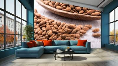 Almonds nut on white wooden table. Almond healthy raw food. Wall mural