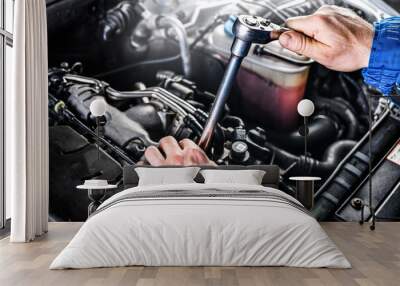 Auto mechanic working on car broken engine in mechanics service or garage. Wall mural