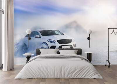 Car drifting on snow in winter mountains. Luxury cars race speed on snowy or ice road with back light. Wall mural