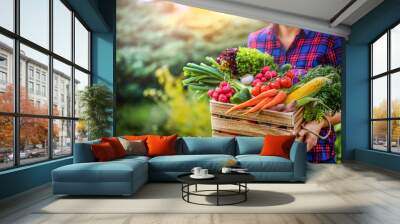 Farmer woman holding wooden box full of fresh raw vegetables. Basket with vegetable (cabbage, carrots, cucumbers, radish, corn, garlic and peppers) in the hands. Wall mural