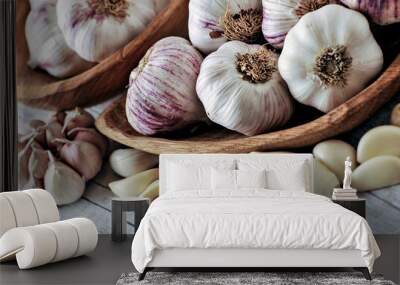 Garlic Cloves and Bulb in wooden bowl on white table. Wall mural